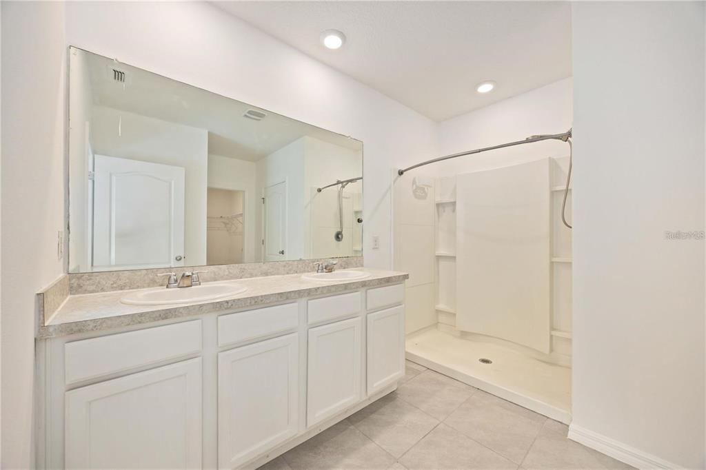 5473 Oro Valley Road Auburndale, FL 33823 - Photo 13 of 17 a bathroom with a shower sink vanity granite and mirror