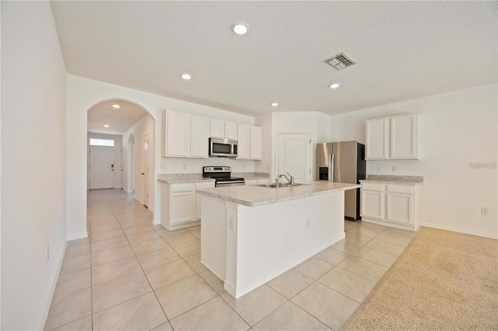 5473 Oro Valley Road Auburndale, FL 33823 - Photo 4 of 17 a large white kitchen with white cabinets