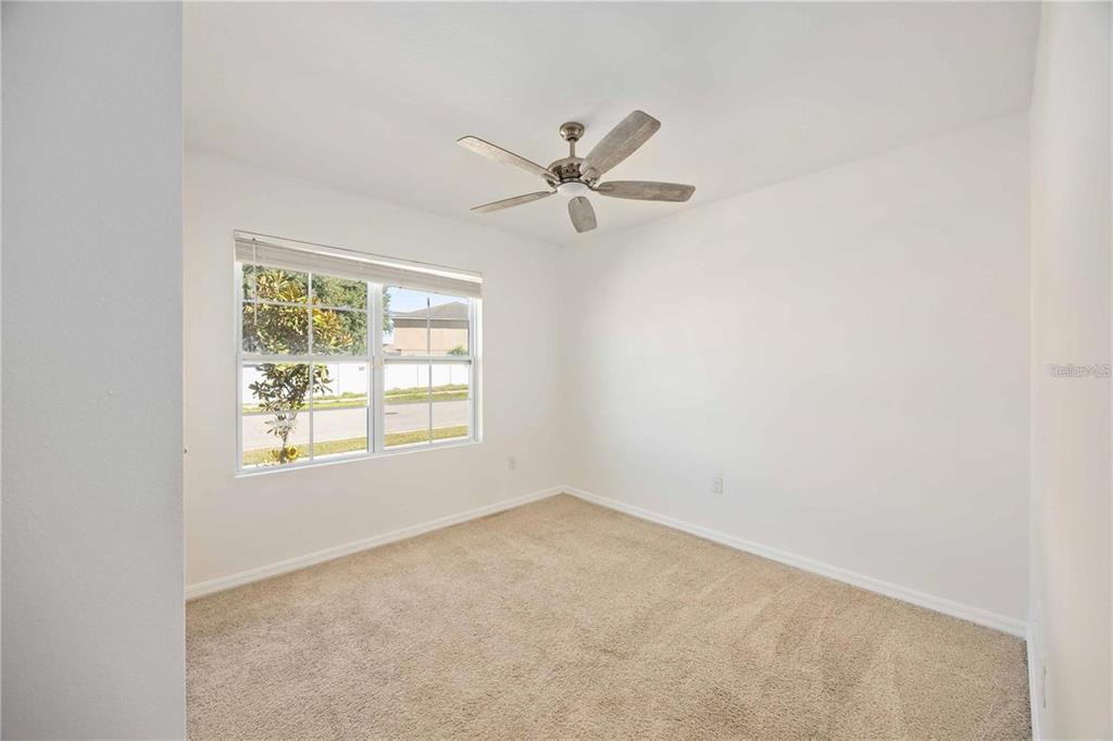 5473 Oro Valley Road Auburndale, FL 33823 - Photo 8 of 17 an empty room with a window and a fan