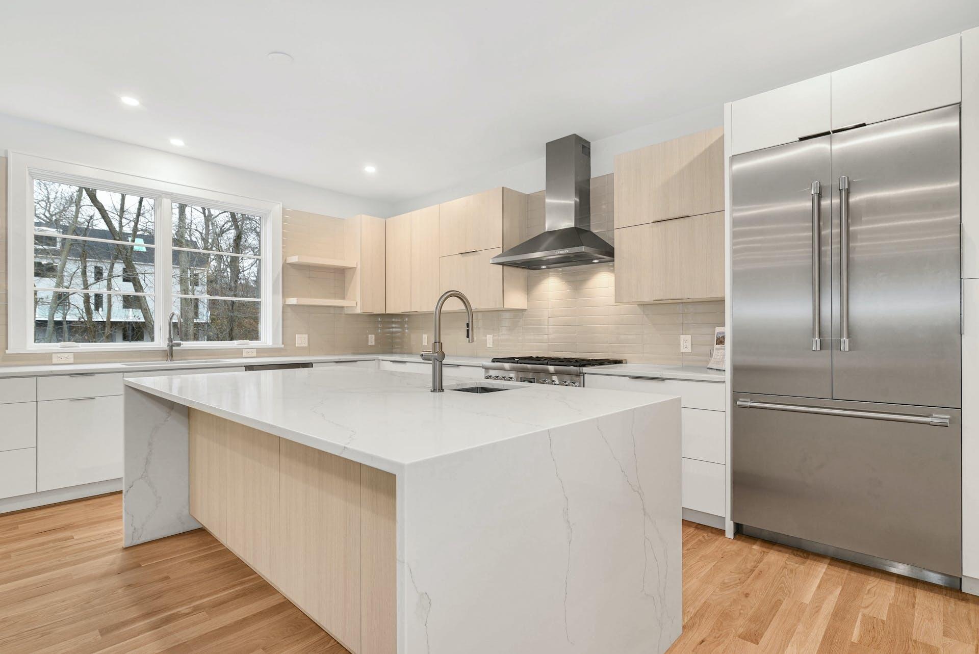 77 Witch Lane Rowayton, CT 06853 - Photo 12 of 39 a kitchen with stainless steel appliances granite countertop a sink a stove a refrigerator and island with wooden floor
