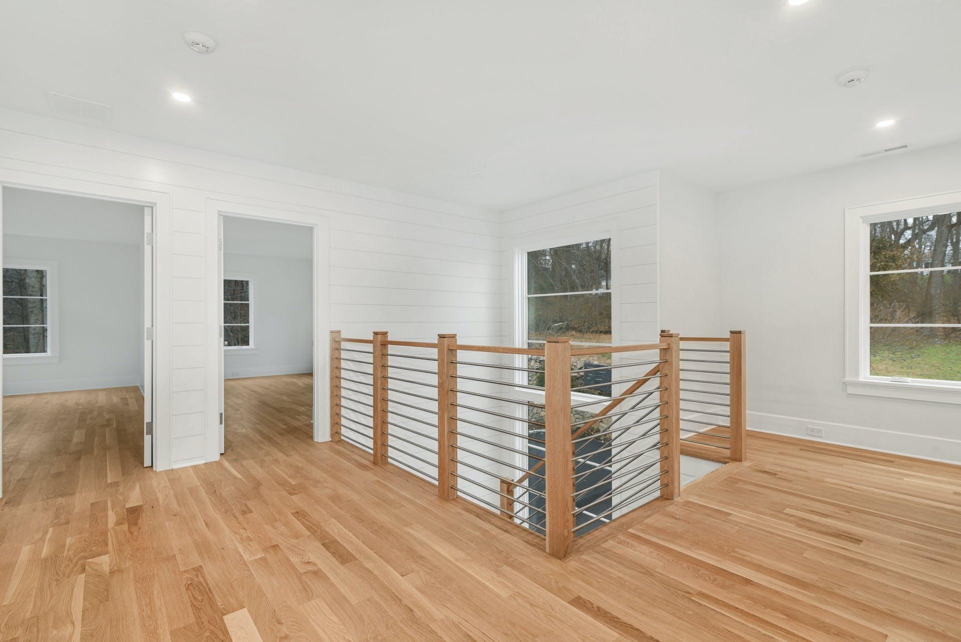77 Witch Lane Rowayton, CT 06853 - Photo 19 of 39 a view of empty room with wooden floor and fan