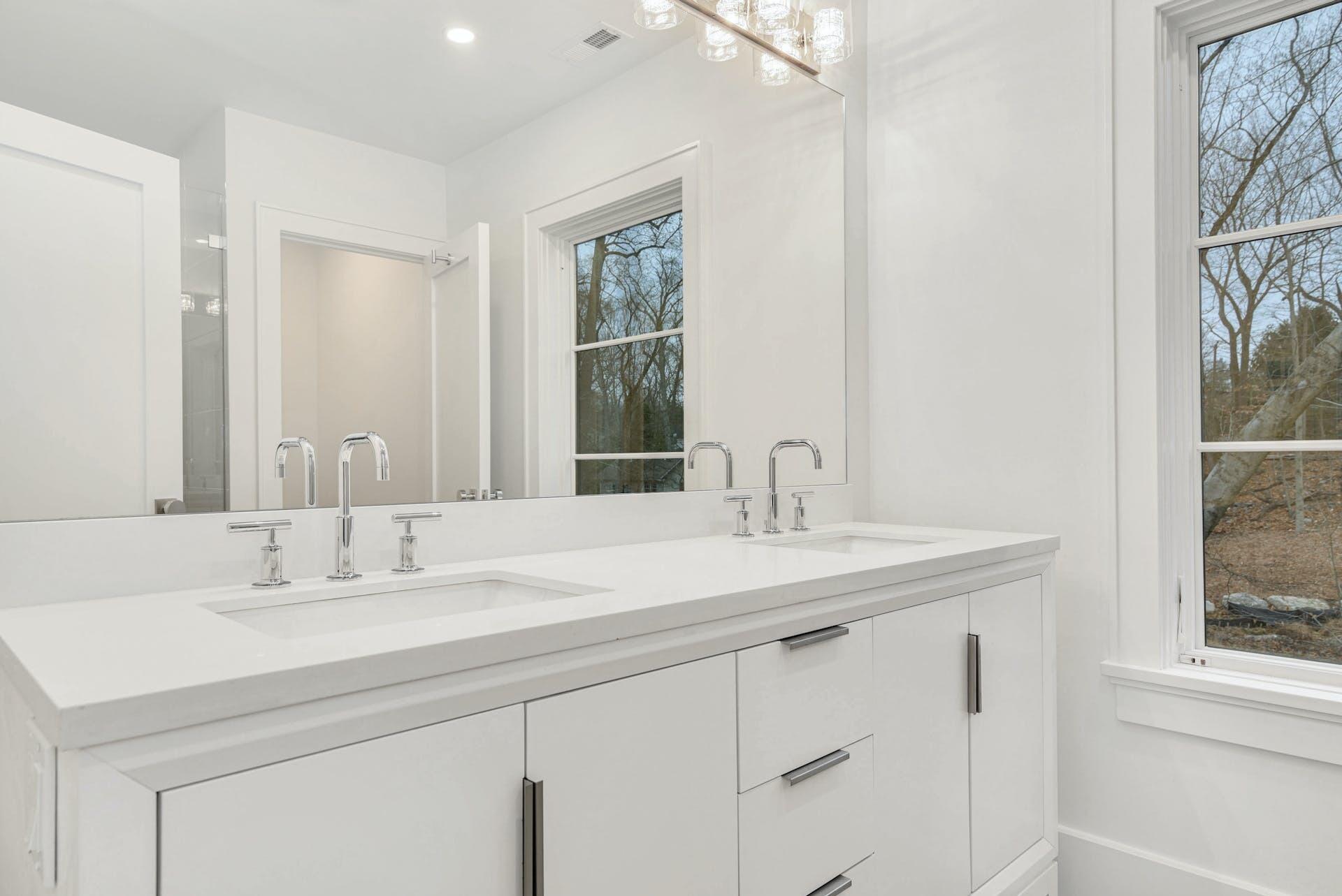 77 Witch Lane Rowayton, CT 06853 - Photo 22 of 39 a bathroom with a sink and a mirror