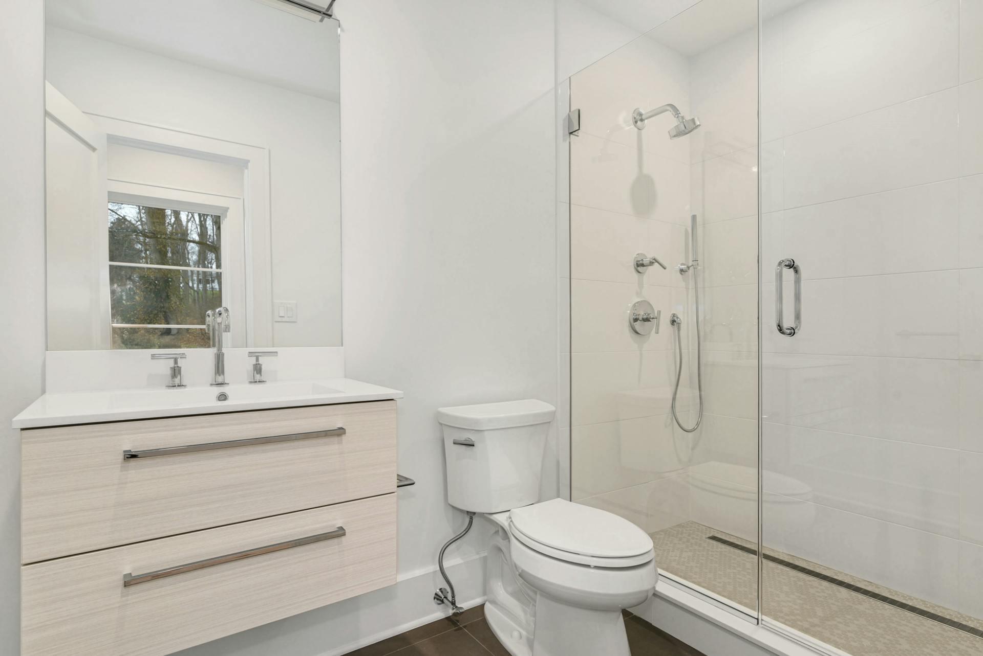 77 Witch Lane Rowayton, CT 06853 - Photo 28 of 39 a bathroom with a sink a toilet and shower