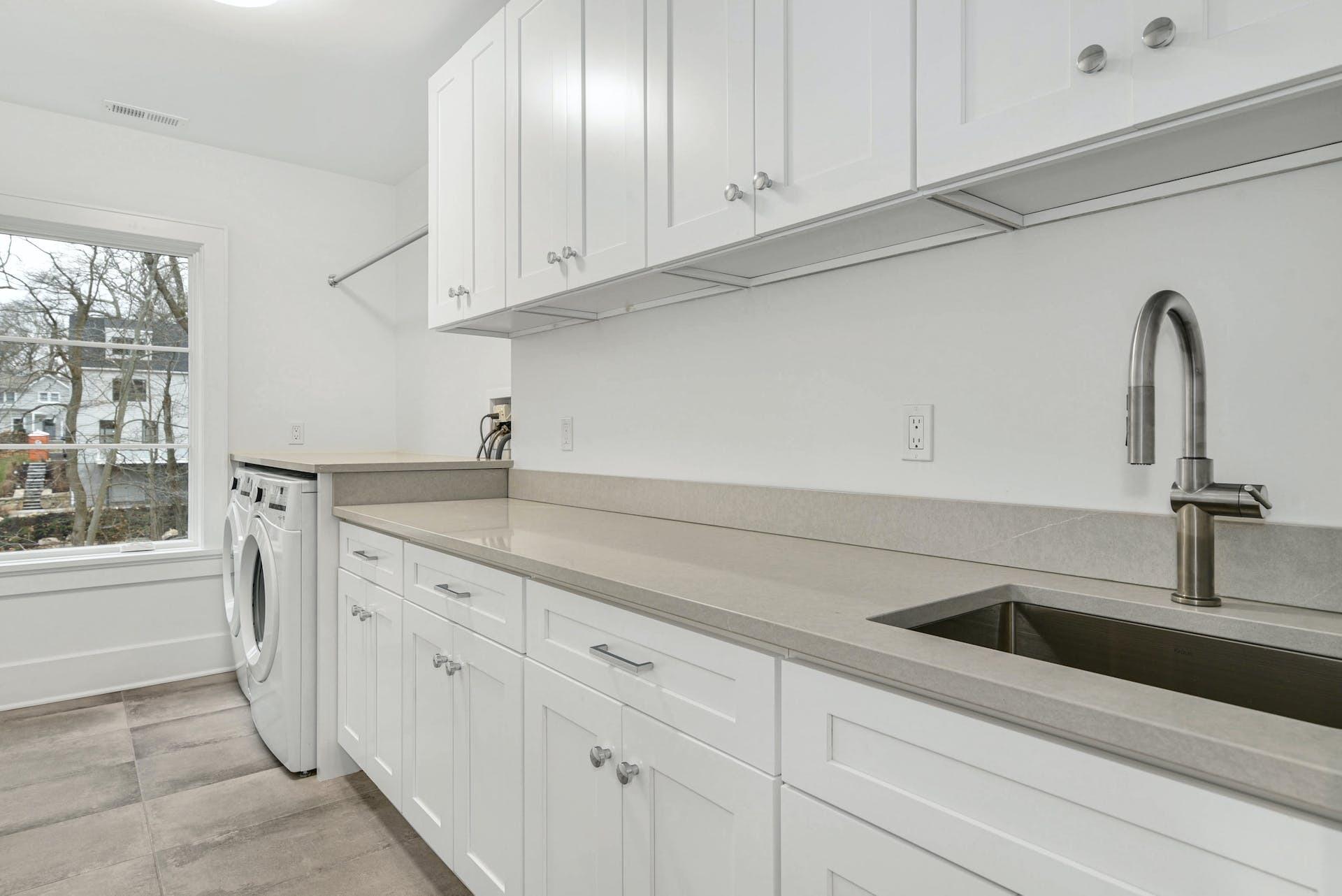 77 Witch Lane Rowayton, CT 06853 - Photo 29 of 39 a kitchen with white cabinets and a sink
