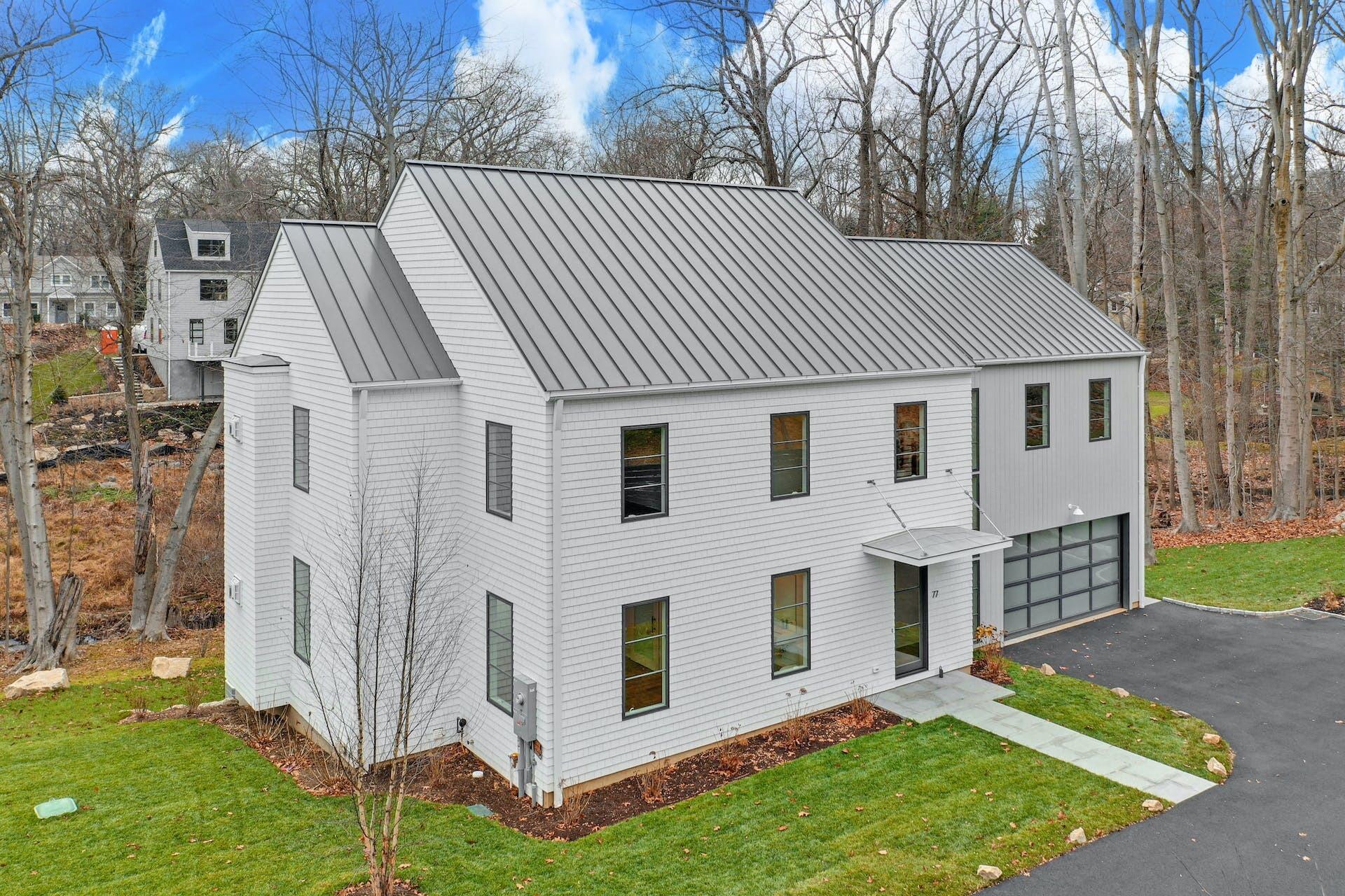 77 Witch Lane Rowayton, CT 06853 - Photo 39 of 39 a view of a white house with a big yard and large trees