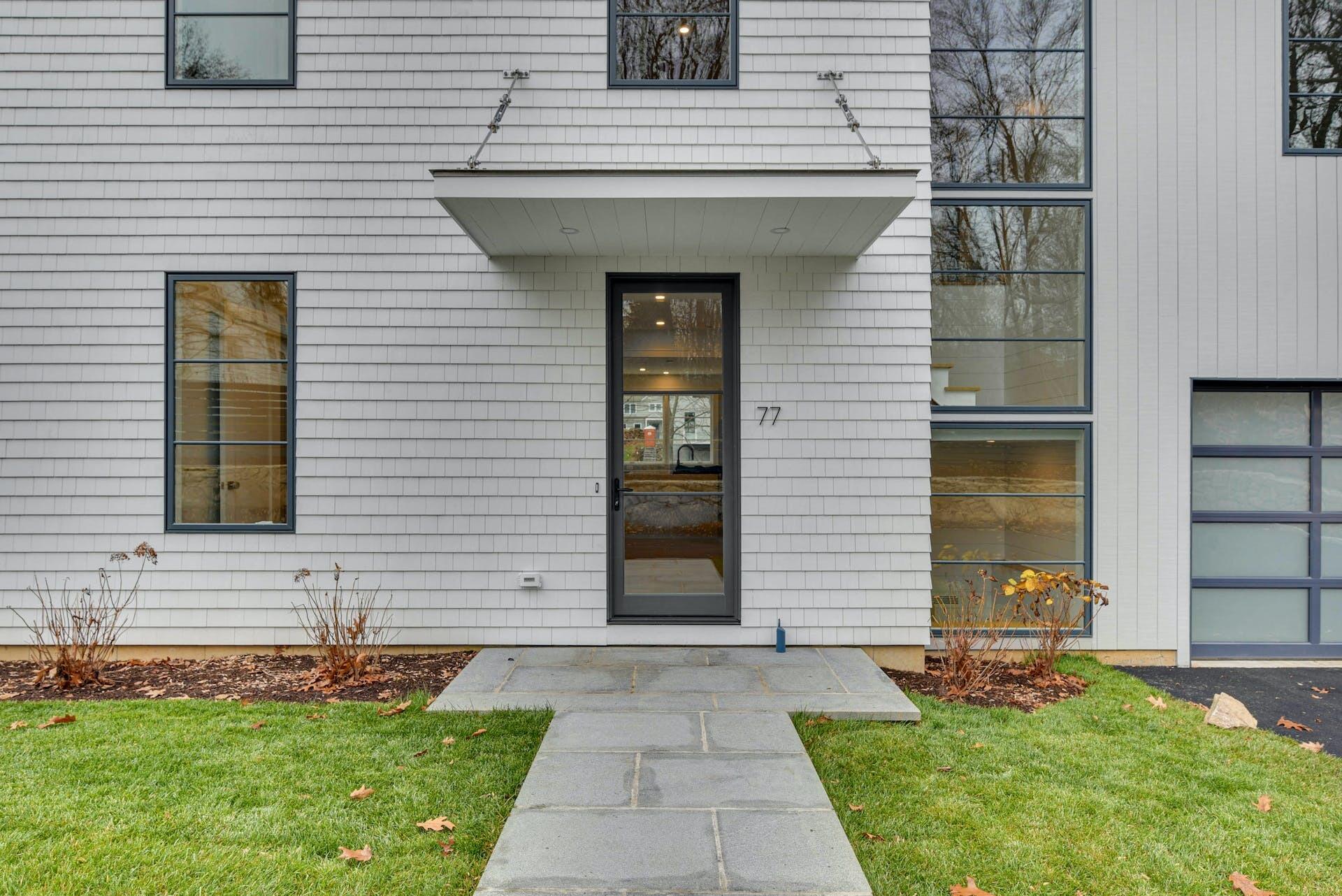 77 Witch Lane Rowayton, CT 06853 - Photo 5 of 39 a front view of a house with a yard