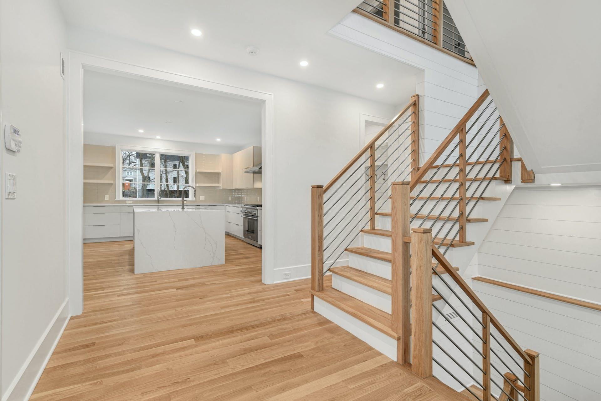 77 Witch Lane Rowayton, CT 06853 - Photo 6 of 39 a view of empty room with wooden floor and kitchen
