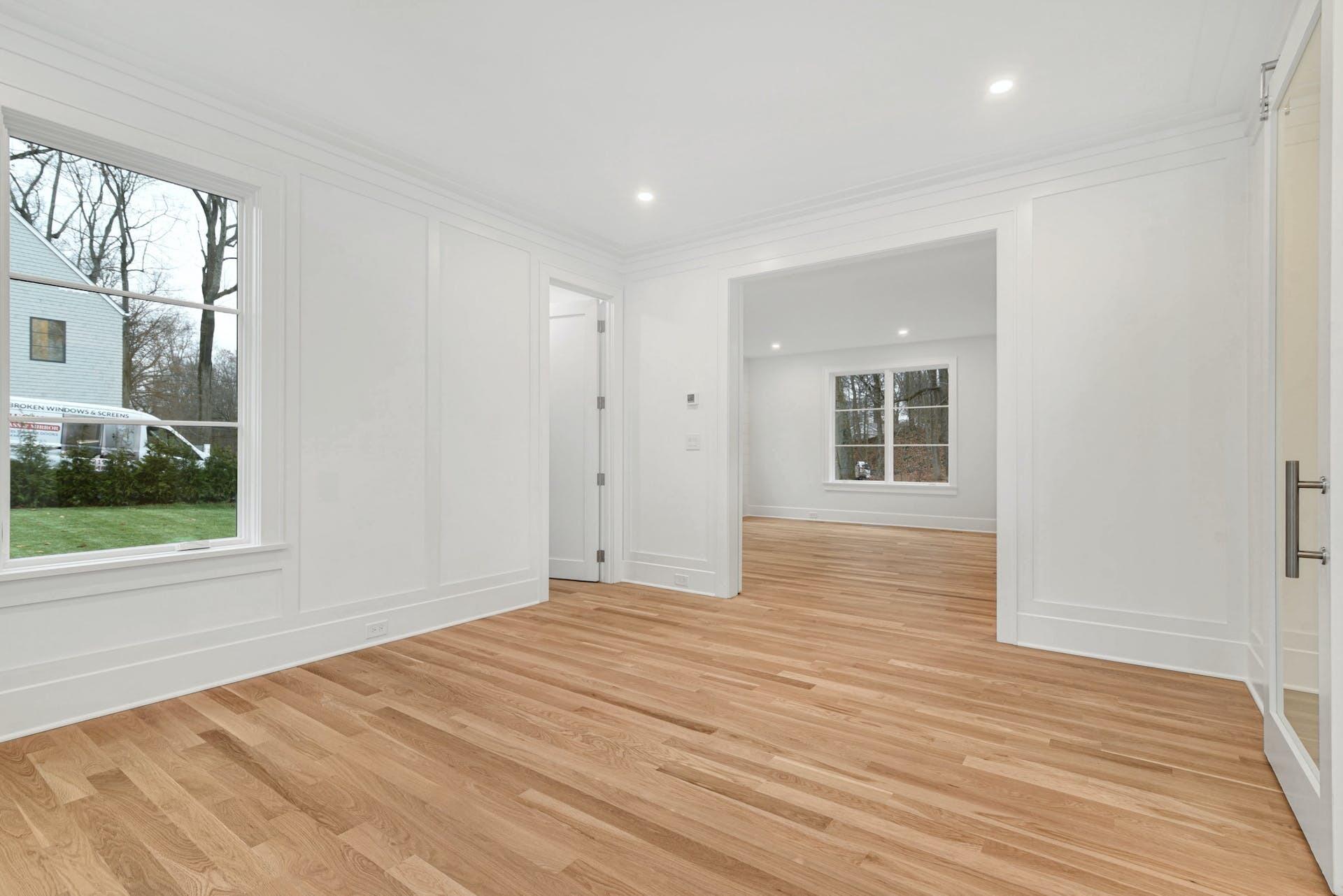 77 Witch Lane Rowayton, CT 06853 - Photo 10 of 39 a view of empty room with wooden floor and fan