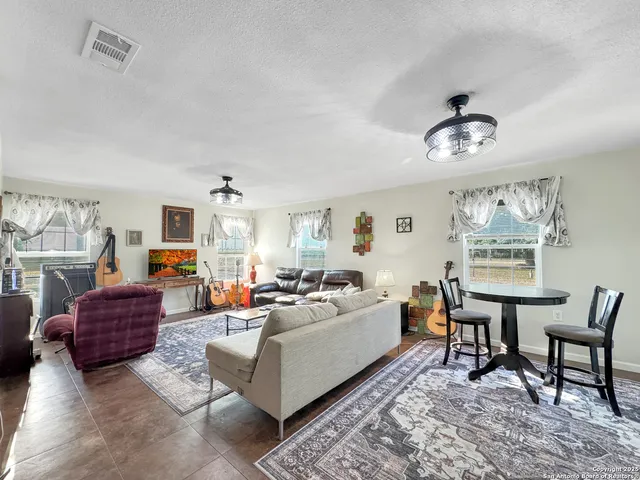 a living room with fireplace furniture and a window
