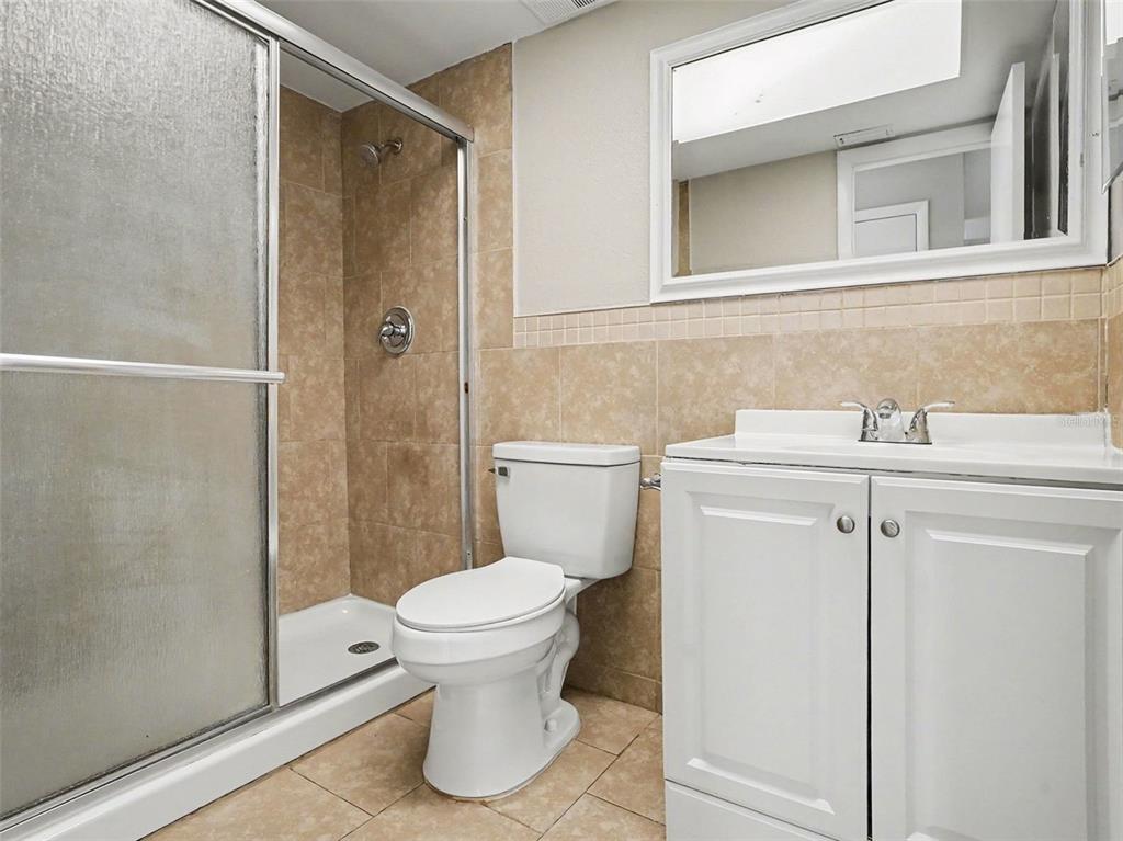 615 Thomas Jefferson Way Orlando, FL 32809 - Photo 15 of 17 a bathroom with a sink toilet and shower