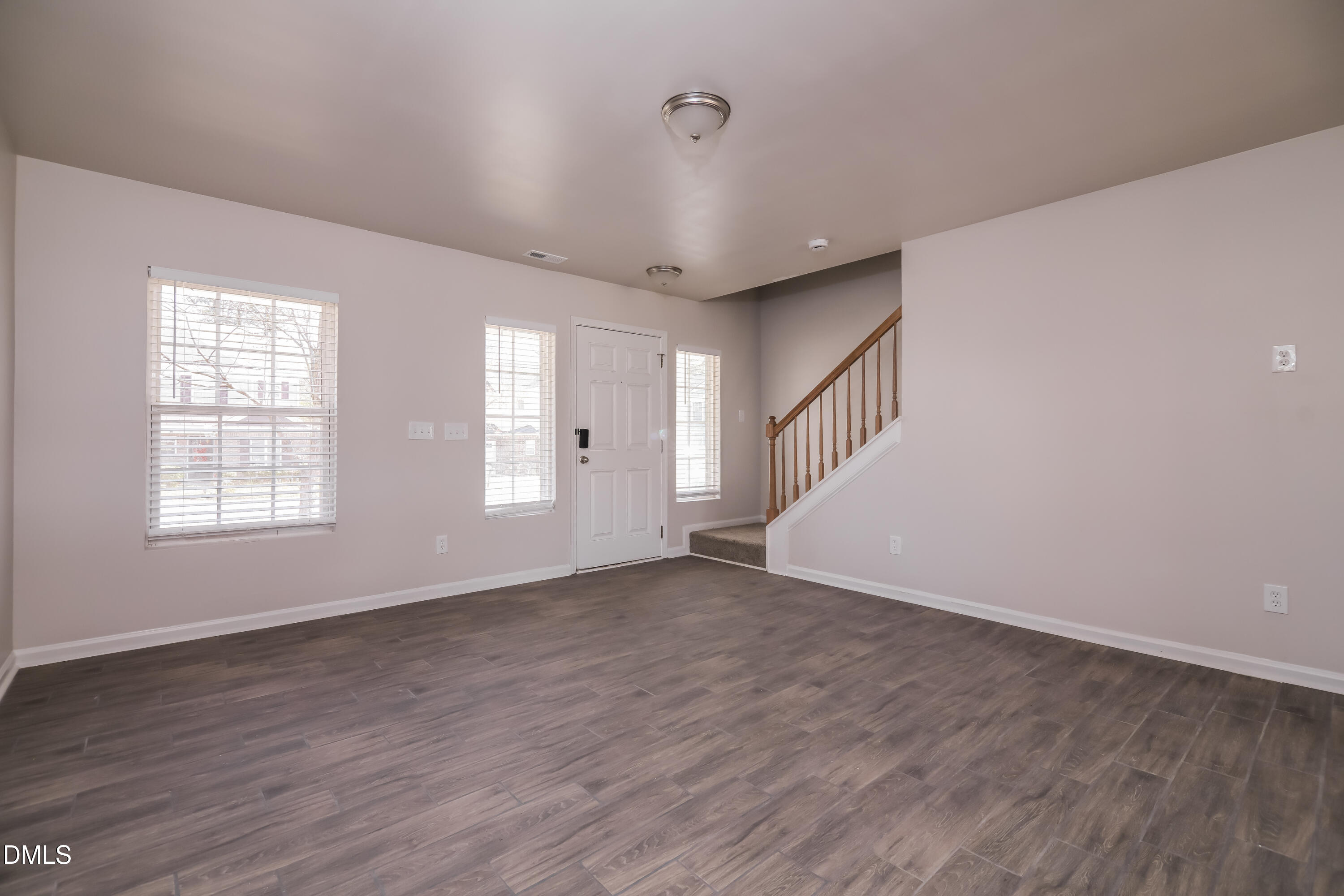 3716 Tryon Ridge Drive Raleigh, NC 27610 - Photo 3 of 17 a view of an empty room with wooden floor and a window