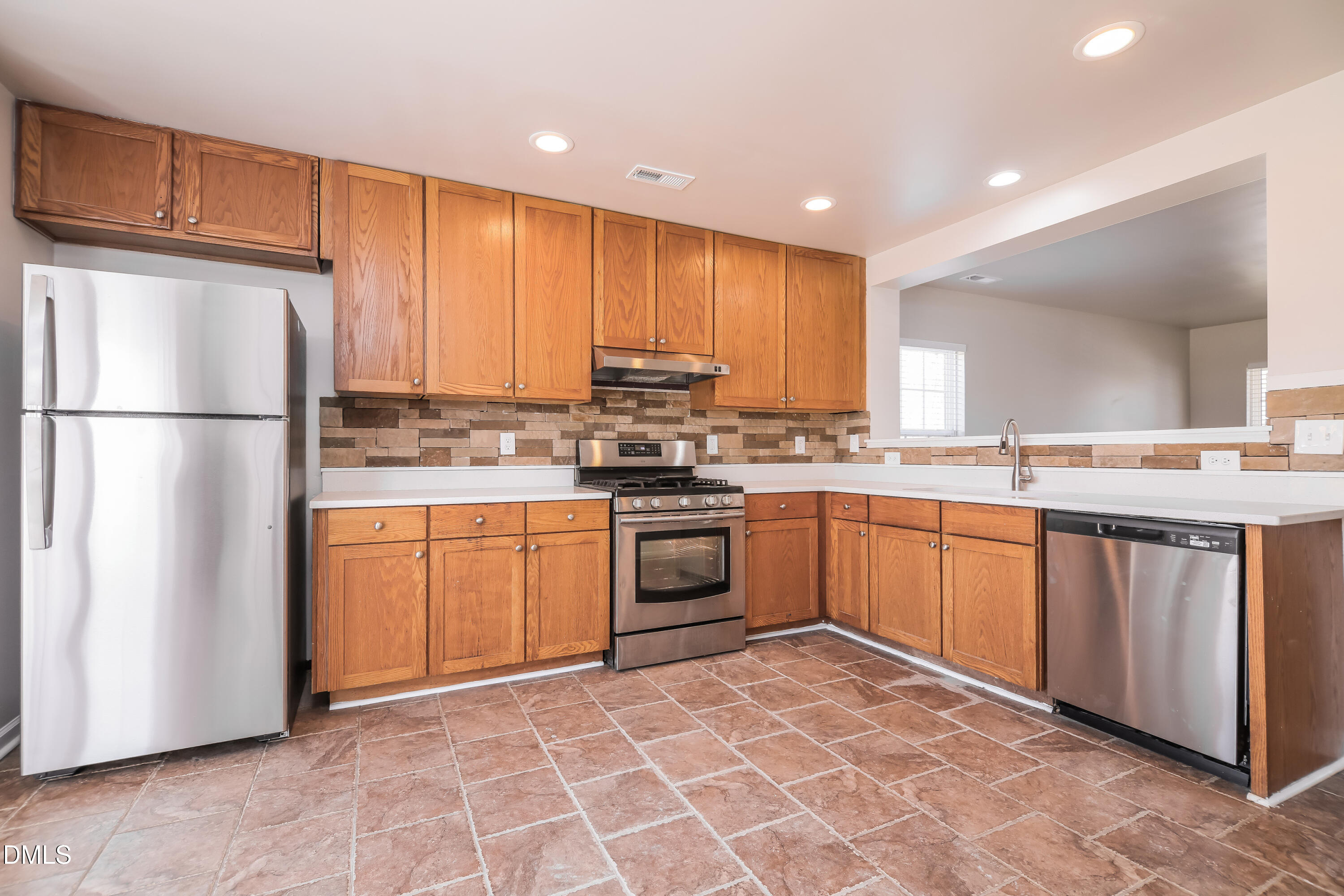 3716 Tryon Ridge Drive Raleigh, NC 27610 - Photo 6 of 17 a kitchen with stainless steel appliances granite countertop a refrigerator sink and cabinets
