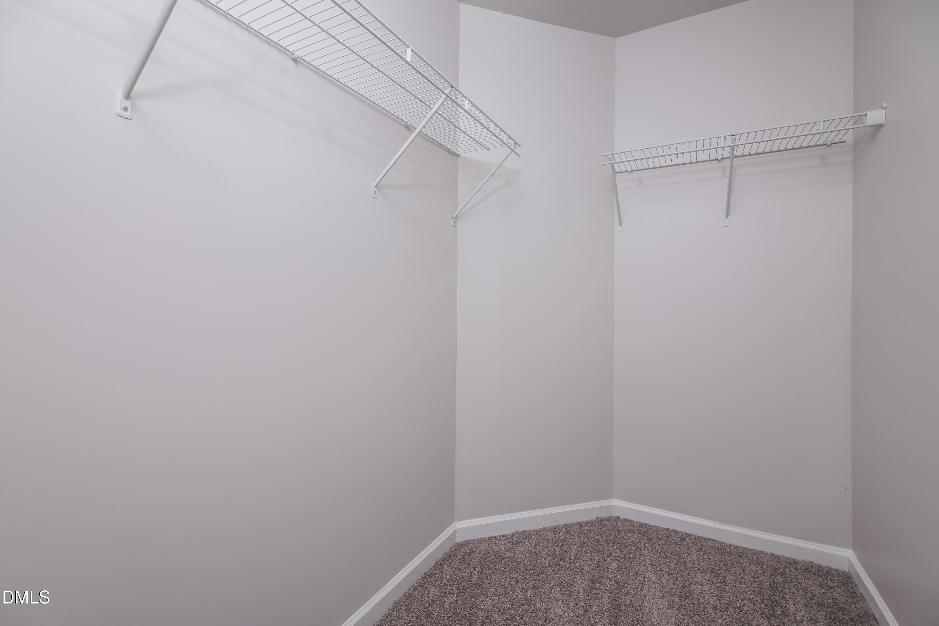 3716 Tryon Ridge Drive Raleigh, NC 27610 - Photo 10 of 17 a view of a room with racks on the wall