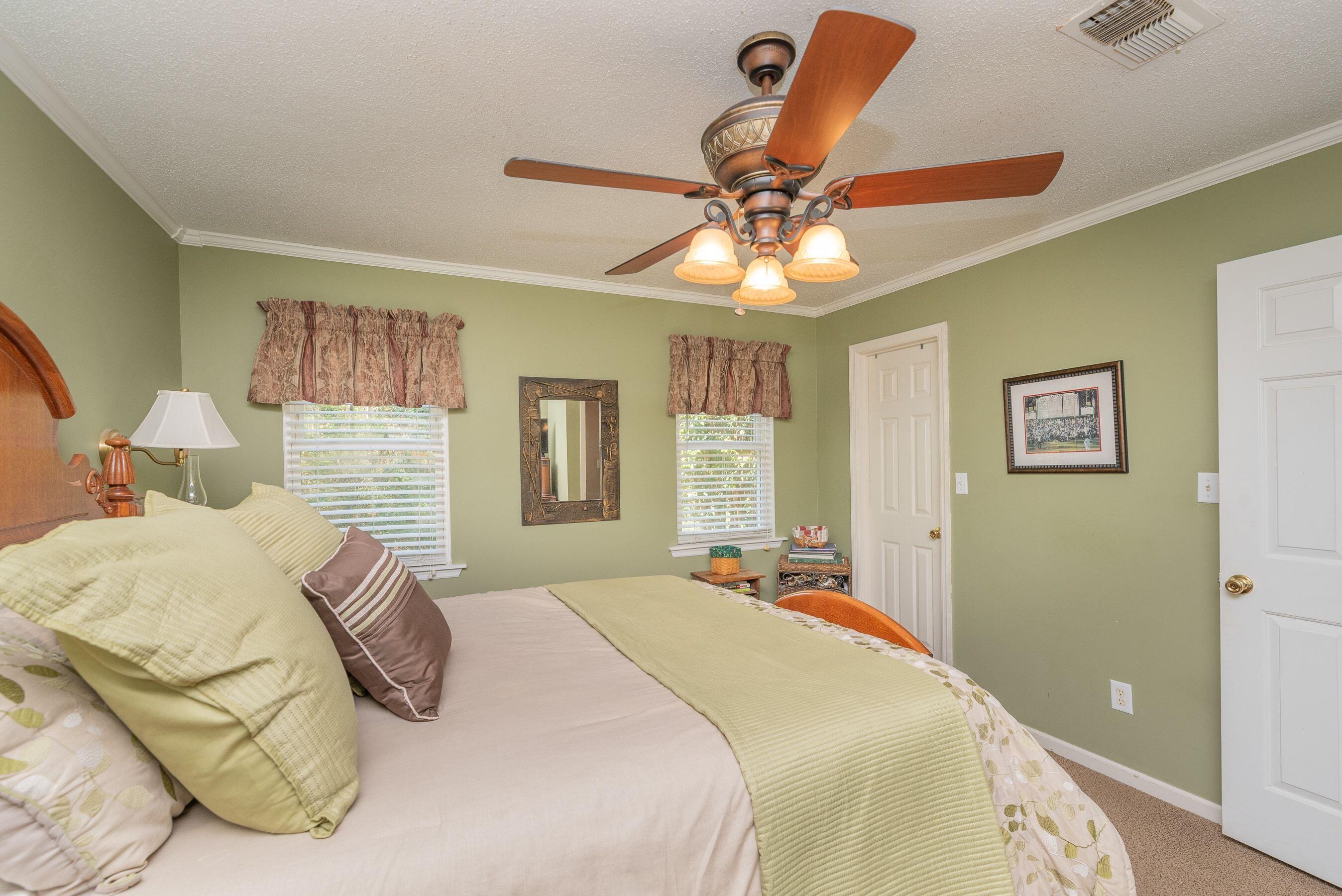 1117 Ridgemont Drive Aiken, SC 29803 - Photo 30 of 49 a bedroom with a bed and a chandelier