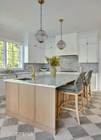 a view of a hallway to a livingroom with furniture and a fireplace