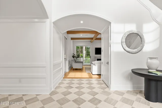 a bathroom with a bathtub and a chandelier