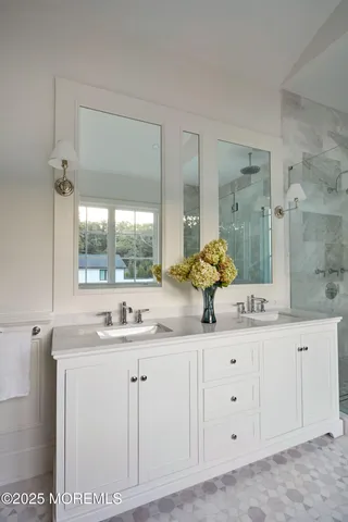 a bathroom with a double vanity sink mirror and double