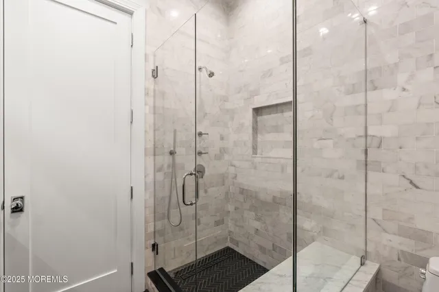 a bathroom with a granite countertop toilet a sink and a mirror