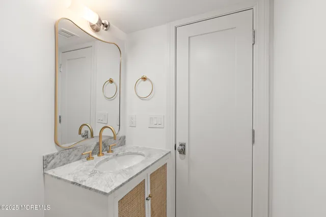 a view of a kitchen with white cabinets