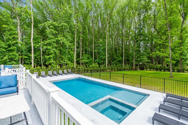 swimming pool view with a outdoor seating