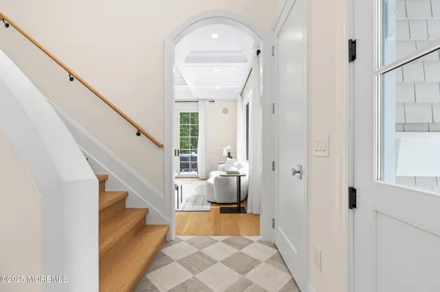 a living room with a couch and a potted plant