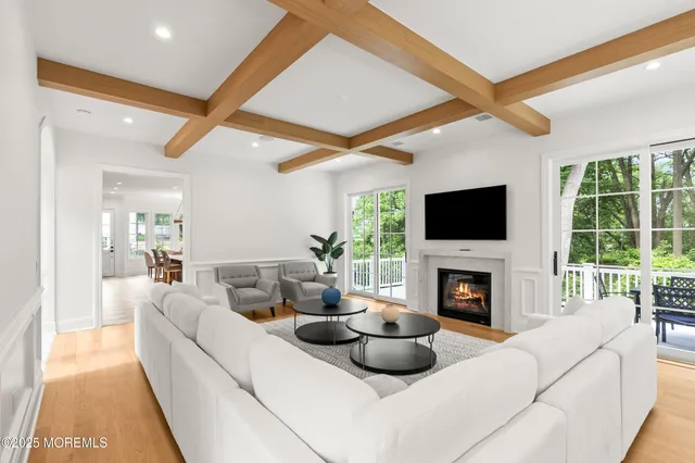 a living room with a fireplace a flat screen tv and a fireplace