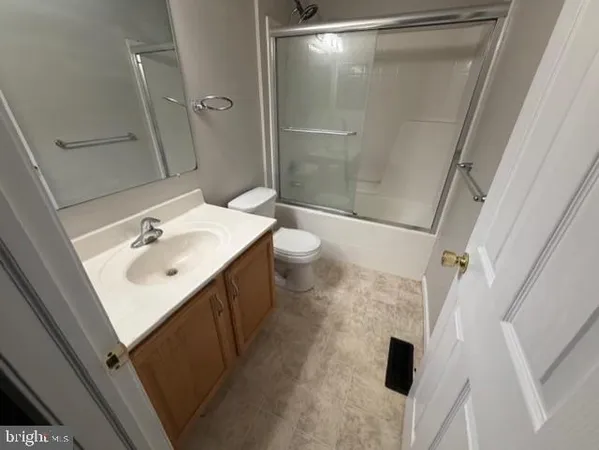 a large kitchen with granite countertop a sink and cabinets