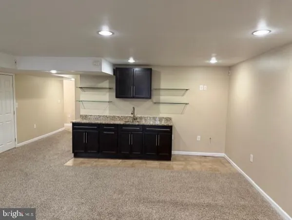 an empty room with fan and entrance