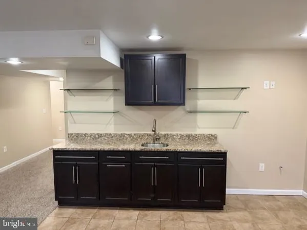 an empty room with windows and ceiling fan