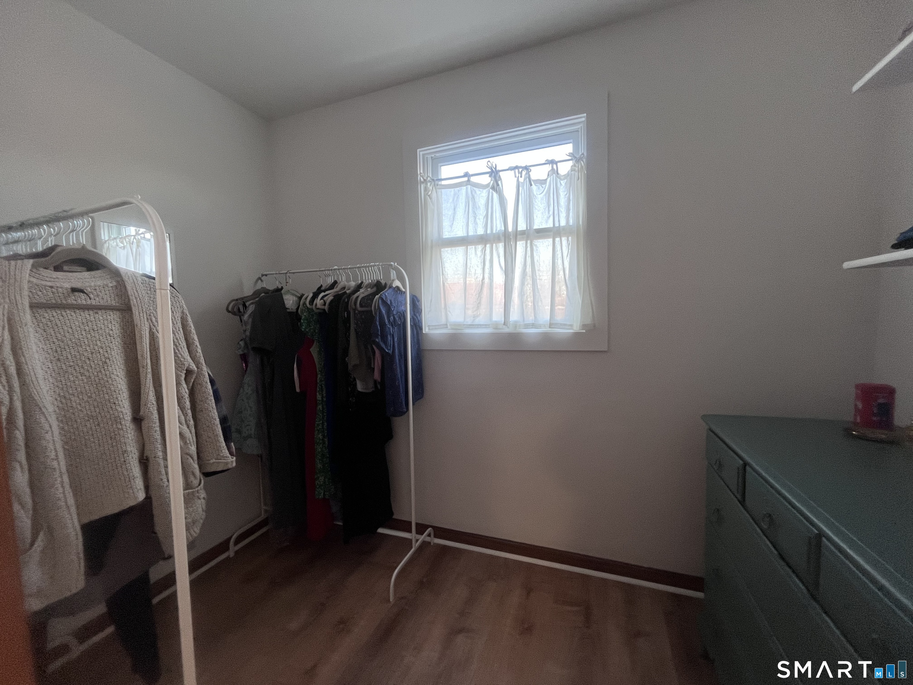 124 Thorpe Street Fairfield, CT 06824 - Photo 8 of 23 a view of walk in closet with window and refrigerator