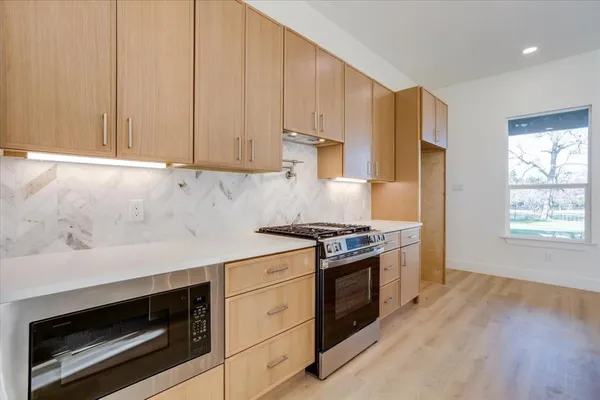 a kitchen with a stove a sink and a refrigerator