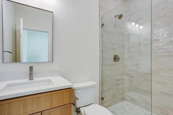 a bathroom with a sink a toilet and mirror