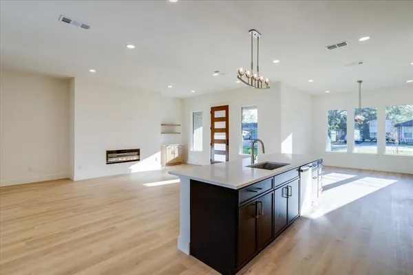 a view of kitchen with stainless steel appliances granite countertop a sink a stove and a microwave
