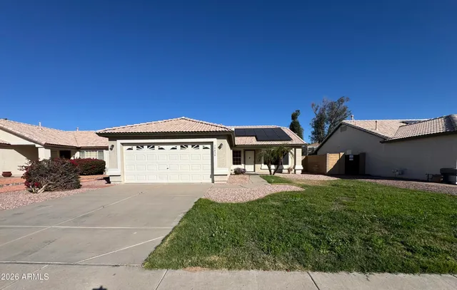 a view of a house with a yard and garage