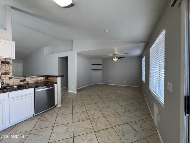 a view of kitchen with refrigerator and window