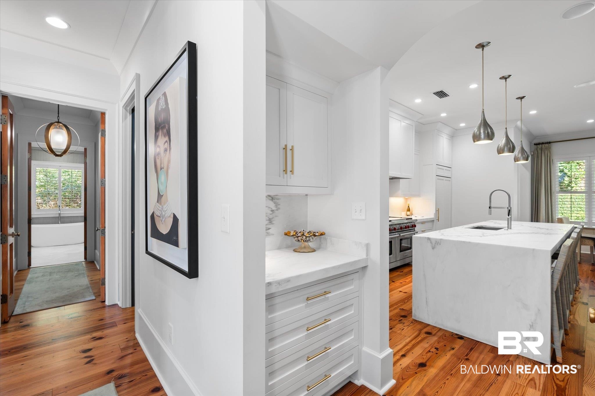 320 Long Court Mobile, AL 36608 - Photo 22 of 61 Interior space featuring a healthy amount of sunlight, a center island with sink, and light hardwood / wood-style flooring