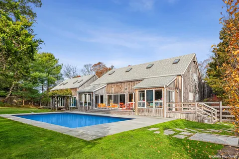 a view of a house with swimming pool and sitting area
