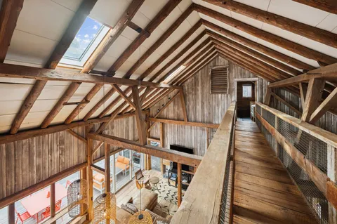 a bedroom with bed and wooden floors