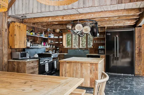 a kitchen with stainless steel appliances granite countertop a sink and a refrigerator