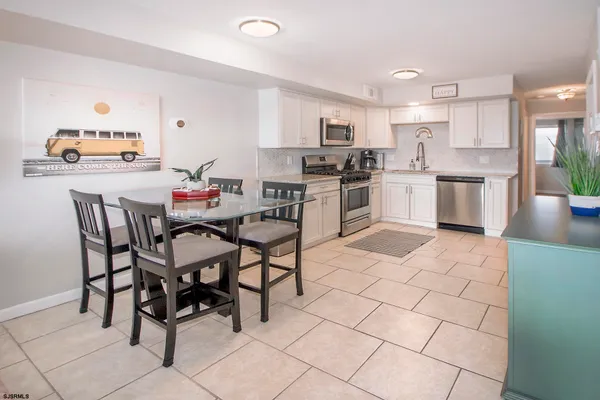 a kitchen with stainless steel appliances kitchen island granite countertop a sink cabinets and counter space