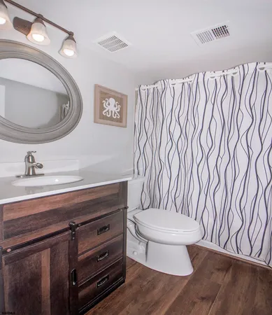 a bathroom with a toilet a sink and a mirror