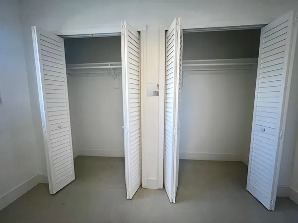 an empty room with a empty space and windows