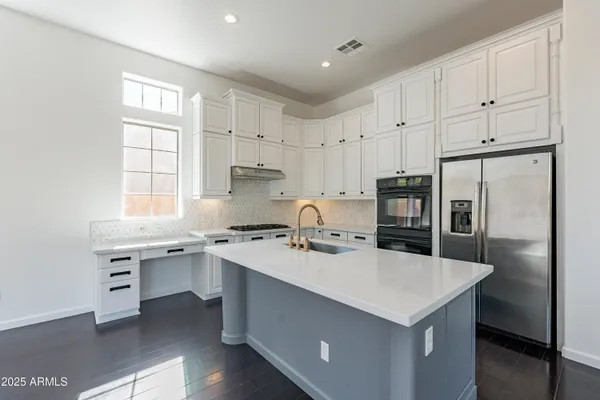 a kitchen that has a sink a stove and window