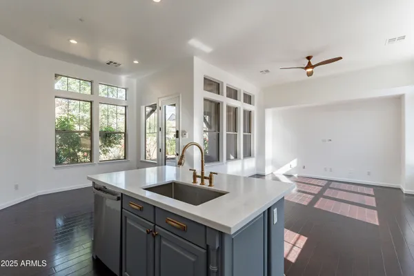 a living room with stainless steel appliances furniture and a rug