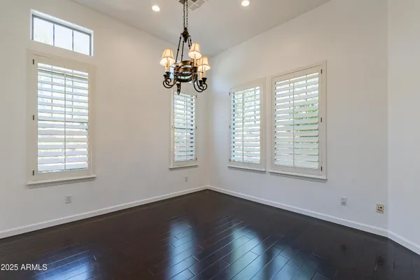 a view of a room with wooden flooring and chandelier