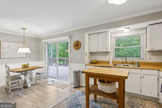 a kitchen with a table chairs and a window