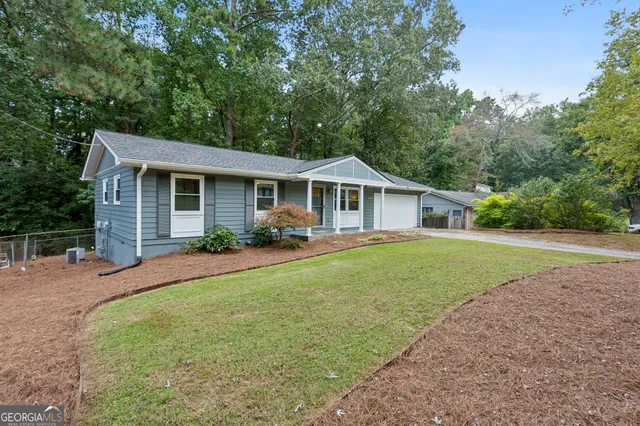 a front view of house with yard and green space