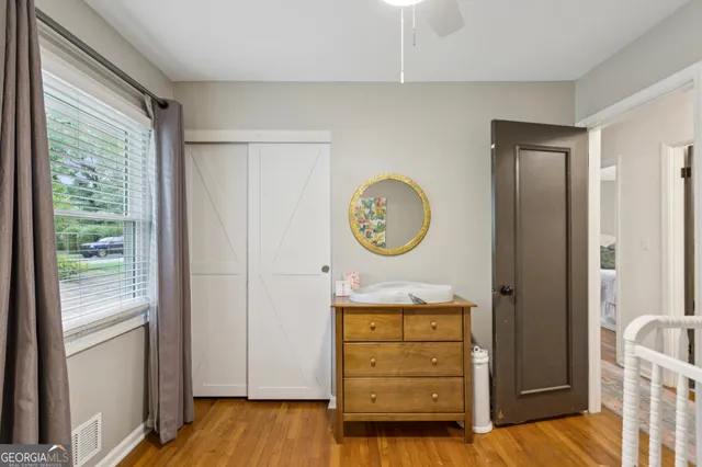 a view of a hallway to rooms