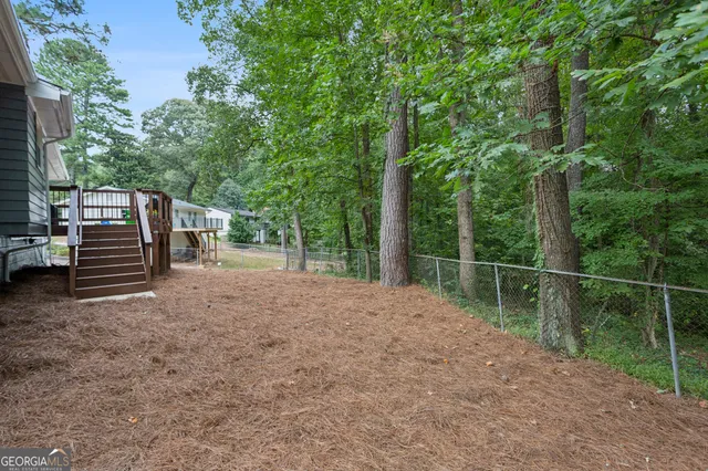 a view of a backyard with plants and a backyard
