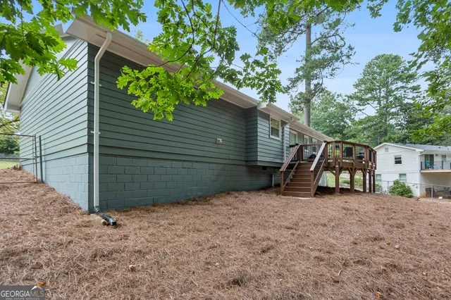 a view of a house with a tree and a yard